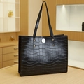 Classic black tote bag with crocodile texture and golden rivets in a luxury setting - Crocodile Pattern Style / Black