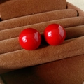 Macro view of glossy red pearl stud earrings placed on a brown velvet jewelry box - Silver Pin - Red - Medium