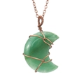 Macro detail of handmade moon-shaped green crystal pendant with vintage copper wire wrapping - Green Aventurine