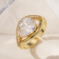 Close-up of 18K gold plated ring featuring a pear-cut zircon and adjustable band - 14286/Pear Shaped Main Stone Ring / 18K Gold