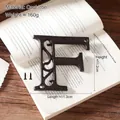 Vintage cast iron letter F sign for wall decor with two mounting screws and rustic finish - Letter F
