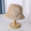 Detail shot of beige faux fur bucket hat material texture on a wooden stand - 56-58cm / Camel