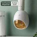 Automatic toothpaste dispenser in amber and white color with minimalist wall mount - Amber