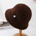 Detail of soft brown faux shearling bucket hat with black bow and vintage white button - Coffee