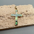 Golden cross pendant with colorful abalone shell inlay displayed on a textured stone - Abalone Shell (Multicolor)