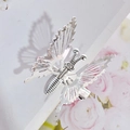 Elegant silver metal butterfly hair clip with hollow wings and spring on floral surface - Integrated Butterfly / Silver