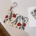 Detailed macro view of vintage floral cotton pouch with zipper and red poppy prints - Red Rose