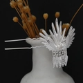 Macro shot of silver phoenix hairpin with leaf tassels on white ceramic vase edges - Spreading Phoenix Double Needle Tassel (F44)