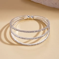 Macro shot of silver triple-layer spiral bangle encrusted with sparkling cubic zirconia - Silver