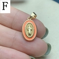 Macro detail of oval Jesus pendant with orange enamel edge and gold plating - Orange