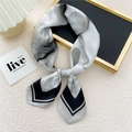 Elegant black and white floral silk scarf tied in a stylish necktie knot style - 19 Skyline Ink Flow Black Grey
