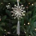 Silver snowflake Christmas ornament with crystal center and grey tassel on a tree - Silver Dusty Miller Leaf