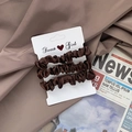 Three-piece set of deep brown satin scrunchies with elegant ruffled design on card - Coffee