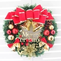 Christmas wreath with red bow, golden bells, and Merry Christmas sign on white wall - Double Bell Style
