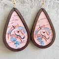 Detailed close-up of teardrop wooden earrings with pink horse and floral pattern - Horse Head Floral