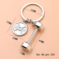 Silver fitness keychain with 45LBS weight plate and dumbbell charm on a pink background - Weightlifting Dumbbell Barbell