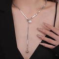Close-up of silver Y-shaped tassel necklace with pearl on neck with black outfit - Y-Shaped Splicing Chain Artificial Pearl Necklace (X3356)