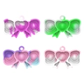 Macro detail of four marble-patterned bow-shaped silicone fidget toy keychains - Bowknot Pop 5.4*2.8cm