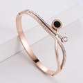 Rose gold crisscross bangle with zircon inlay and black enamel roman numeral charm - Rose Gold
