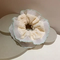 Cream white lace scrunchie with light green wavy edges on a geometric stone base - Green Scalloped Edge - Pleated