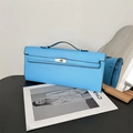 Detail of light blue flat leather handbag with gold twist lock and elegant top handle - Blue