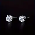 Close-up of square-cut cubic zirconia earrings with a classic four-prong silver setting - White Pair