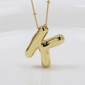 Detailed view of 3D bubble style letter K pendant with golden chain and reflective finish - Letter K (Necklace)