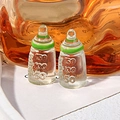 Macro shot of miniature resin feeding bottles with green rings and relief scale markings - Green