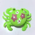 Green crab silicone water toy for kids featuring a decorative pink and white flower pattern - Floral Print Green Crab