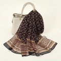 Lightweight black chiffon scarf with beige paisley print draped over a stylish handbag - Black (Paisley Geometric)