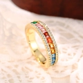 Macro shot of gold eternity ring with rainbow square stones and white side crystals - US 6 / Gold