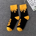 Halloween crew socks with pumpkin prints and orange drip design in black and orange - 01 Halloween-Melting Pumpkin Lantern