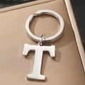 Polished silver metal keychain featuring uppercase letter T on textured gift box - Letter T