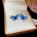 Detail of butterfly stud earrings featuring blue and white crystals in a premium gift box - Silver Earring Post - Silver - Blue