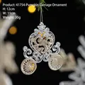 Golden glitter acrylic pumpkin carriage Christmas ornament hanging on a festive branch - Pumpkin Carriage