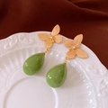 Detail of vintage gold butterfly earrings with green teardrop pendants on a ceramic plate - Gold Butterfly Green Drop Vintage Earrings (30#)