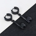 Close-up of black punk style hoop earrings with axe shaped pendants in matte finish - Axe - Black