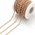 Pink cubic zirconia and white faux pearl DIY chain with gold claw setting on a white spool - 2.5mm Pink