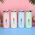 Detail of four colorful vacuum flasks in pink beige blue green with silicone straps - 400ml / Mixed Colors Nice