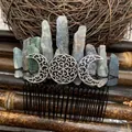 Macro detail of raw crystal hair comb with triple moon symbol and hand-wired stones - Cyanite Black Wire Silver Moon