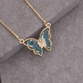 Macro shot of gold necklace with a blue butterfly pendant and sparkling crystals - 8# Lake Blue
