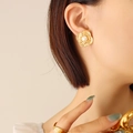 French style gold flower stud earrings with pearl center worn by model on beige background - F600-Gold Earrings