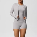 Detailed view of light grey 3-piece fitness set with zip jacket, top and high waist shorts - Frost Grey