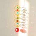 Detail of golden spiral wind chime with colorful crystal beads and a large red crystal ball - Gold Spiral Red Crystal Ball