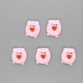 Detailed close-up of five cute pink resin pig charms with red hearts for DIY jewelry making - No Hole Heart Piggy