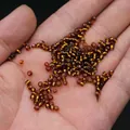 Amber transparent glass seed beads for DIY jewelry making held in hand for scale - 3mm / 15g / Coffee