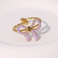 Detail of gold bow ring featuring purple enamel finish and textured adjustable band - Purple