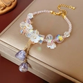 Detailed shot of crystal flower bracelet with gold chain and lavender faceted pendants - Bracelet-Pink