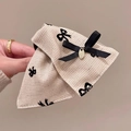 Detail of beige herringbone bow hair clip with black pattern and gold charm - Claw Clip Style / Off White