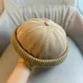 Detail of khaki corduroy docker hat featuring ribbed texture and thick rolled cuff edge - Adjustable / Khaki Knit Edge Skull Cap